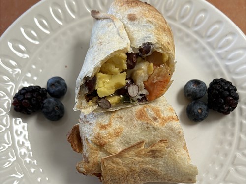 Southwest style cheesy breakfast wrap with scrambled eggs ( Vegetarian )
